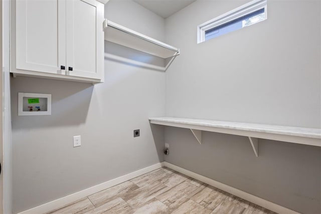 13120 Knight Island Dr, Oklahoma City, OK 73142 - clothes washing area with electric dryer hookup, baseboards, light wood-style flooring, washer hookup, and cabinet space