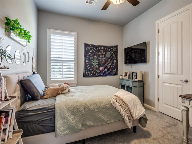 bedroom with visible vents, a ceiling fan, and carpet flooring
