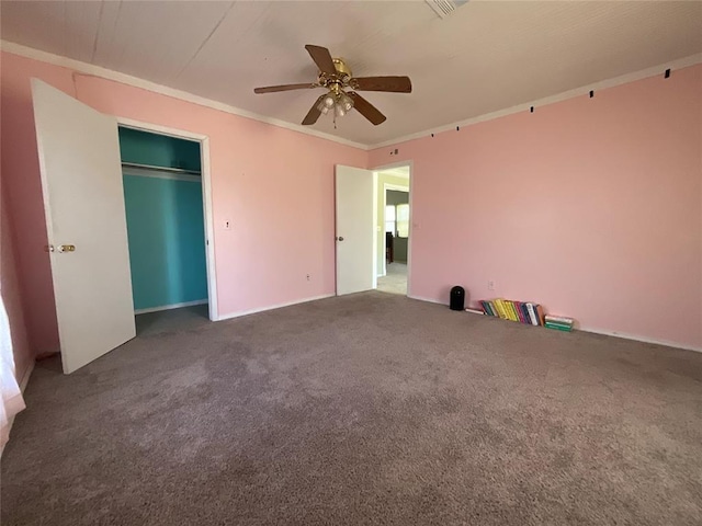 unfurnished bedroom featuring ceiling fan, crown molding, and carpet floors