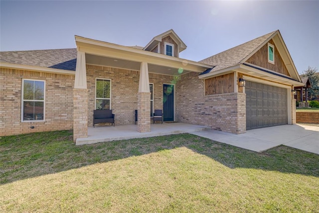 308 W Kerby Ave, Washington, OK 73080 - view of front of house featuring a garage, a front yard, concrete driveway, and brick siding