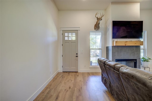 308 W Kerby Ave, Washington, OK 73080 - foyer featuring light wood finished floors, a tiled fireplace, and baseboards
