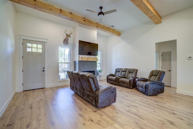 308 W Kerby Ave, Washington, OK 73080 - living room with baseboards, a fireplace, beam ceiling, ceiling fan, and wood finished floors