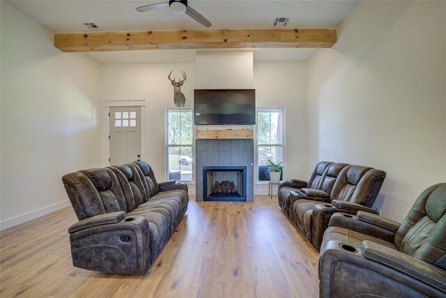 308 W Kerby Ave, Washington, OK 73080 - living area with light wood finished floors, baseboards, beam ceiling, and a healthy amount of sunlight