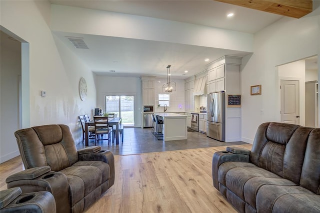 308 W Kerby Ave, Washington, OK 73080 - living room with baseboards, a chandelier, recessed lighting, light wood-style floors, and visible vents