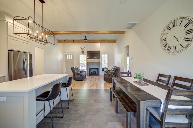 308 W Kerby Ave, Washington, OK 73080 - dining area featuring visible vents, beamed ceiling, an inviting chandelier, and a fireplace