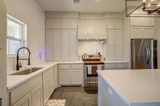 308 W Kerby Ave, Washington, OK 73080 - kitchen with tile patterned flooring, premium range hood, backsplash, appliances with stainless steel finishes, and a sink