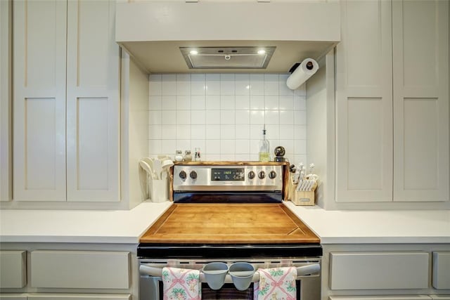 308 W Kerby Ave, Washington, OK 73080 - kitchen featuring light countertops, decorative backsplash, and stainless steel range with electric stovetop