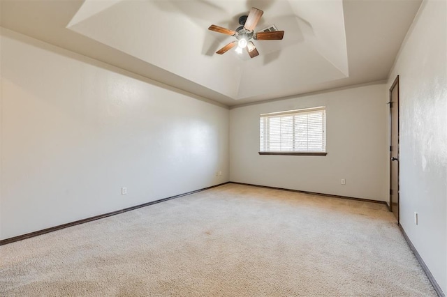 19605 Talavera Ln, Edmond, OK 73012 - empty room with baseboards, a tray ceiling, light colored carpet, and a ceiling fan