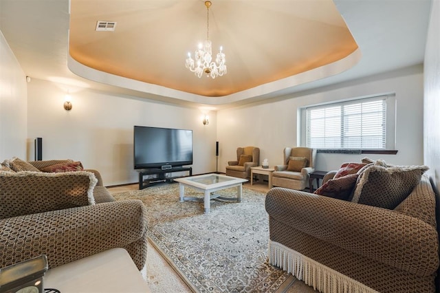 19605 Talavera Ln, Edmond, OK 73012 - living area featuring visible vents, a raised ceiling, and a chandelier