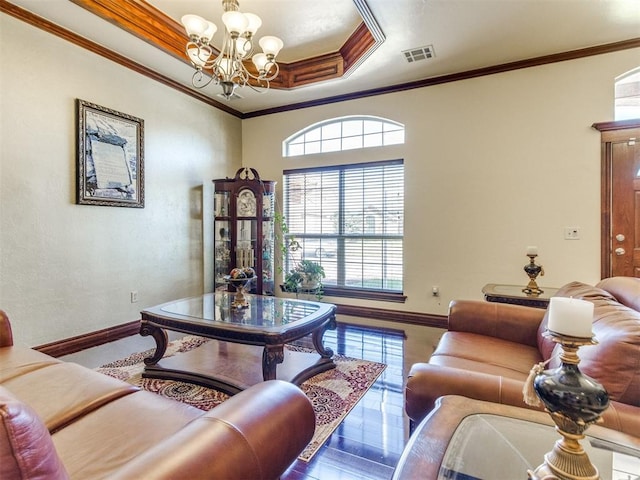 living area featuring a chandelier, baseboards, ornamental molding, a raised ceiling, and wood finished floors