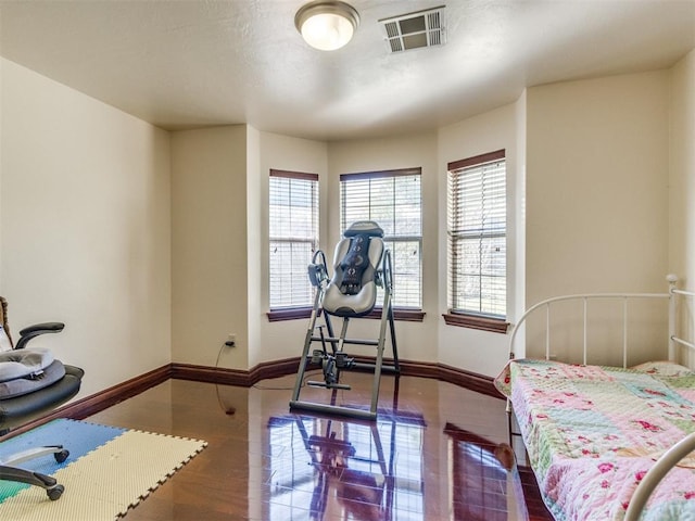 bedroom featuring baseboards and wood finished floors