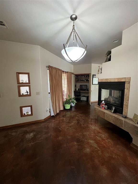unfurnished living room featuring concrete floors, visible vents, baseboards, and a tile fireplace