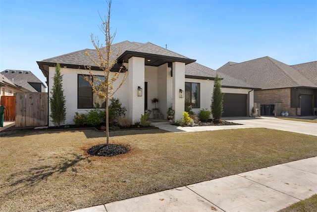8416 NW 130th St, Oklahoma City, OK 73142 - view of front facade with concrete driveway, brick siding, a garage, and a front lawn