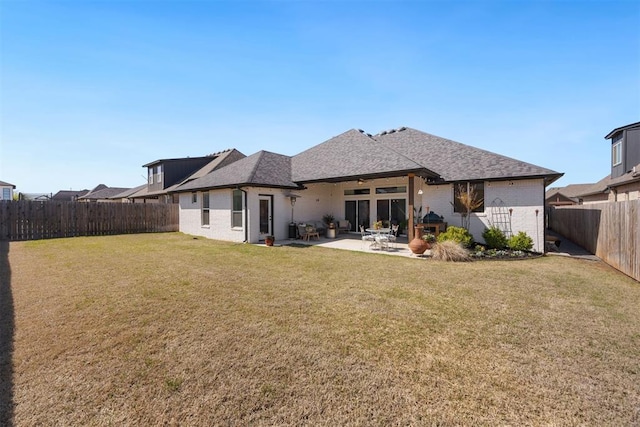 8416 NW 130th St, Oklahoma City, OK 73142 - rear view of house with a patio, a yard, a fenced backyard, and brick siding