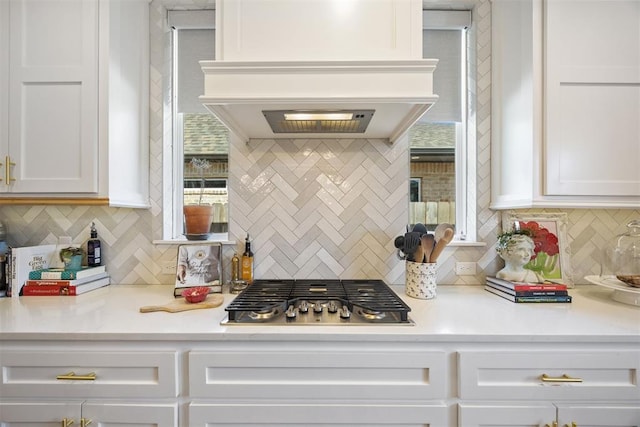 8416 NW 130th St, Oklahoma City, OK 73142 - kitchen with custom exhaust hood, tasteful backsplash, white cabinetry, and stainless steel gas cooktop