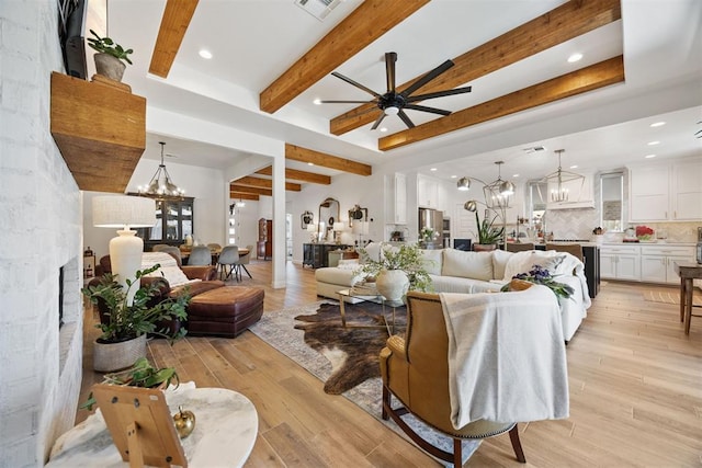 8416 NW 130th St, Oklahoma City, OK 73142 - living room featuring ceiling fan with notable chandelier, light wood-style flooring, visible vents, recessed lighting, and beam ceiling