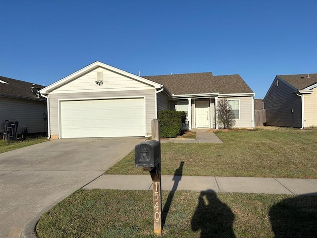 ranch-style home featuring an attached garage, driveway, and a front lawn