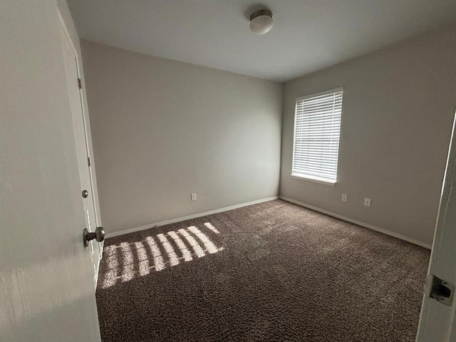 empty room with carpet floors and baseboards