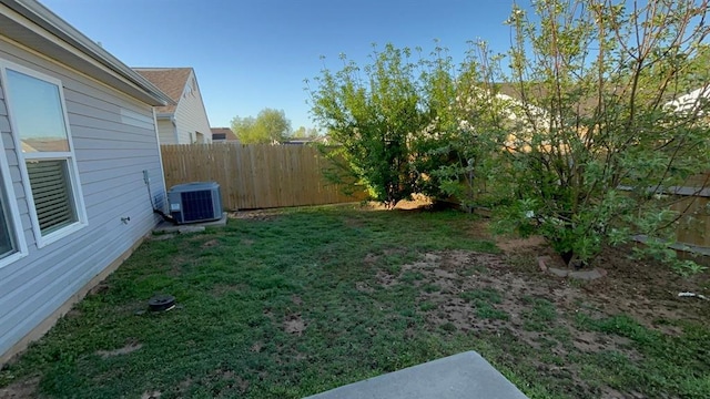 view of yard with fence and central AC