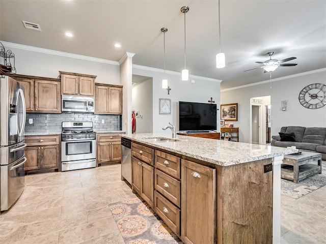 207 Lyla Glen St, Washington, OK 73093 - kitchen featuring appliances with stainless steel finishes, a sink, open floor plan, crown molding, and decorative backsplash