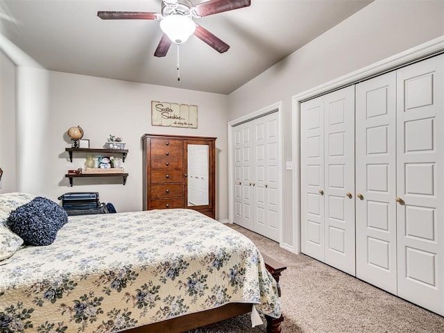 207 Lyla Glen St, Washington, OK 73093 - bedroom with light colored carpet, two closets, ceiling fan, and baseboards