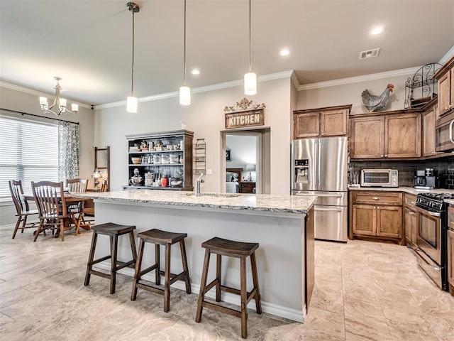 207 Lyla Glen St, Washington, OK 73093 - kitchen with appliances with stainless steel finishes, crown molding, a chandelier, a sink, and a kitchen bar