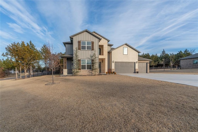 view of front of property featuring board and batten siding, concrete driveway, and a garage