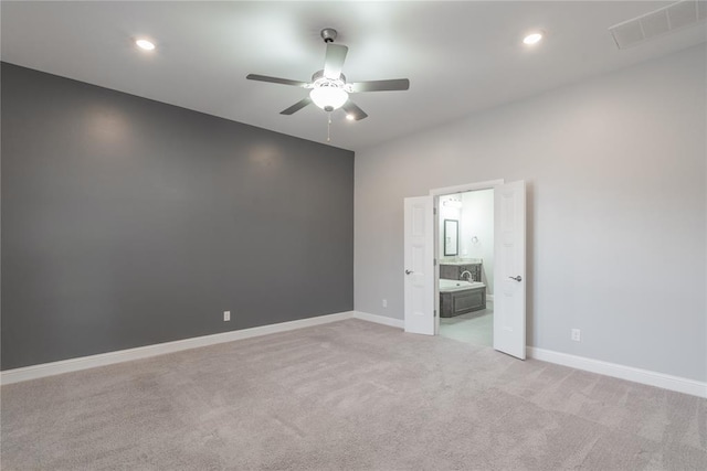 empty room featuring visible vents, ceiling fan, light carpet, and baseboards