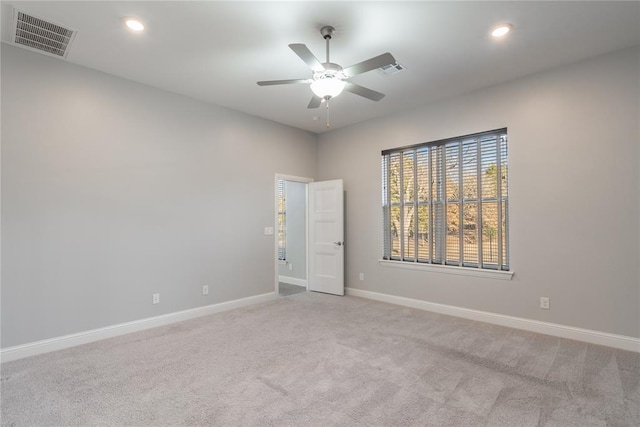 carpeted spare room with visible vents, baseboards, a ceiling fan, and recessed lighting