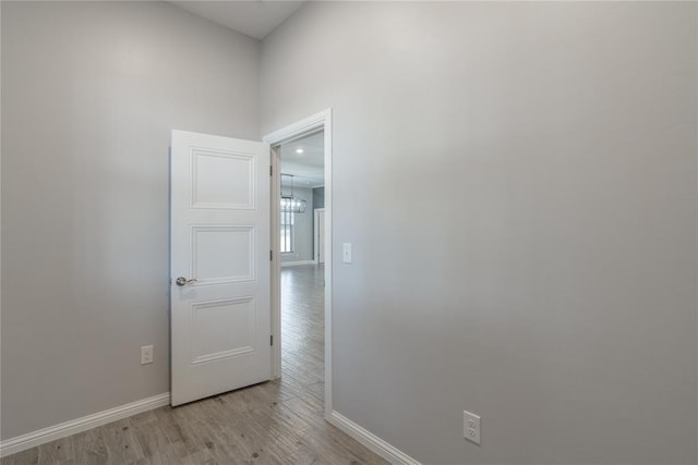 empty room featuring light wood-style flooring and baseboards