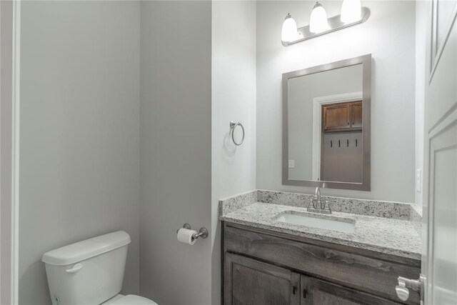 bathroom featuring toilet and vanity