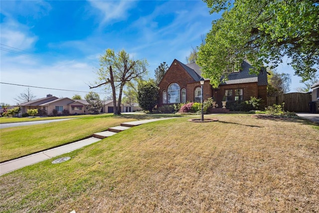 500 NW 41st St, Oklahoma City, OK 73118 - view of front of property with a gate, a front yard, fence, and brick siding