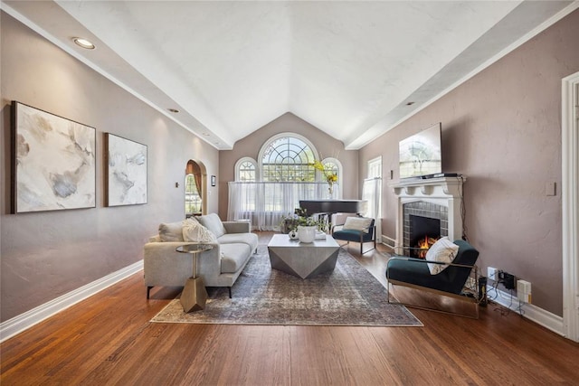 500 NW 41st St, Oklahoma City, OK 73118 - living room featuring arched walkways, wood finished floors, lofted ceiling, a tile fireplace, and baseboards