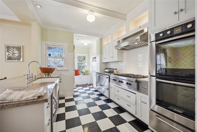 500 NW 41st St, Oklahoma City, OK 73118 - kitchen with appliances with stainless steel finishes, under cabinet range hood, white cabinetry, a warming drawer, and dark floors