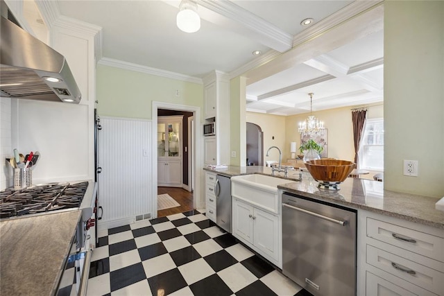500 NW 41st St, Oklahoma City, OK 73118 - kitchen with an inviting chandelier, wall chimney exhaust hood, dark floors, appliances with stainless steel finishes, and coffered ceiling