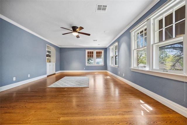 500 NW 41st St, Oklahoma City, OK 73118 - spare room with baseboards, a ceiling fan, crown molding, visible vents, and wood finished floors