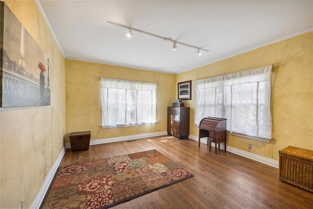 500 NW 41st St, Oklahoma City, OK 73118 - sitting room featuring rail lighting, wood finished floors, baseboards, and ornamental molding