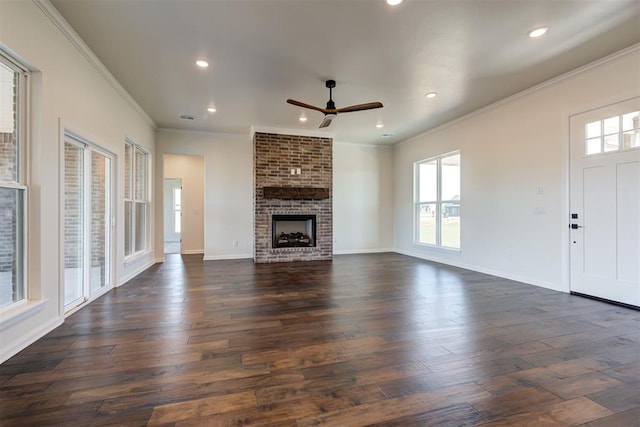 unfurnished living room featuring plenty of natural light, dark wood-style flooring, baseboards, and ceiling fan