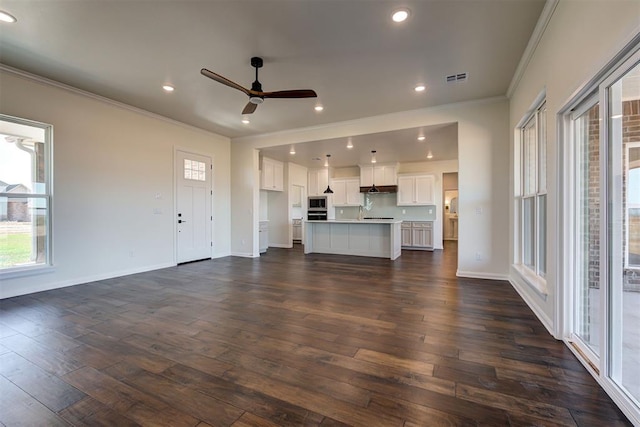 unfurnished living room featuring dark wood-type flooring, crown molding, ceiling fan, and recessed lighting