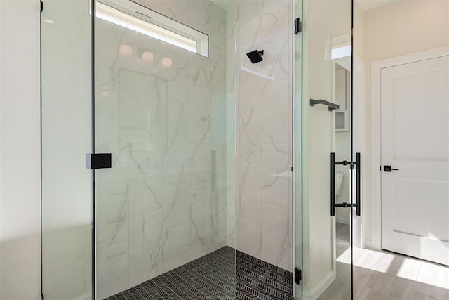 full bath featuring a marble finish shower
