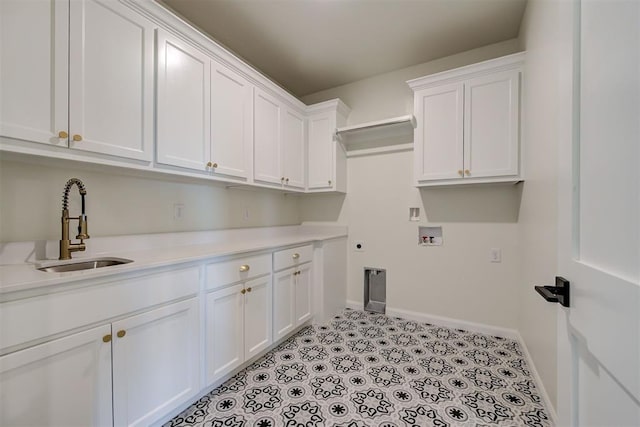 laundry area featuring baseboards, electric dryer hookup, washer hookup, cabinet space, and a sink