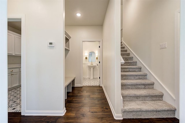 staircase with baseboards and wood finished floors