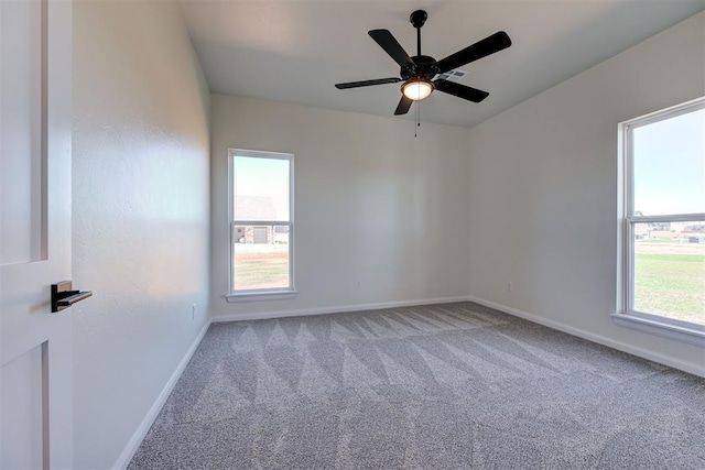 empty room with carpet flooring, baseboards, and ceiling fan