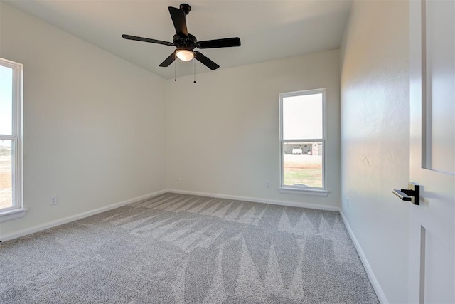 unfurnished room featuring light colored carpet, baseboards, and a ceiling fan