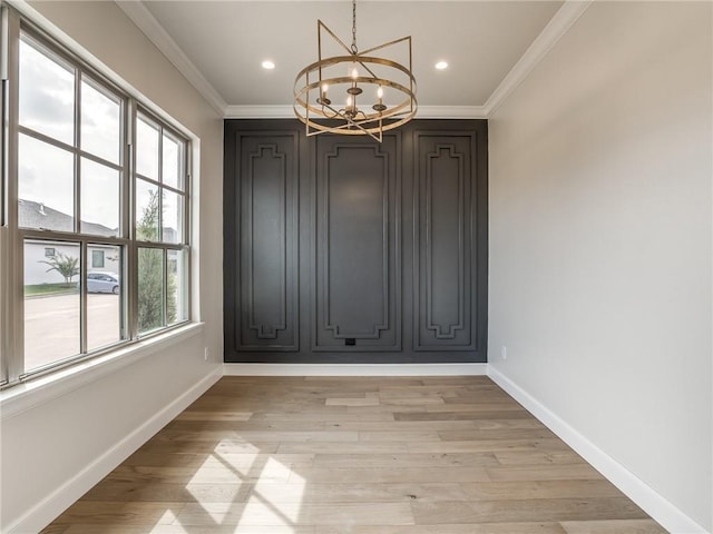 unfurnished dining area with ornamental molding, baseboards, recessed lighting, and a chandelier