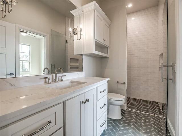 bathroom featuring vanity, recessed lighting, toilet, a shower stall, and brick floor