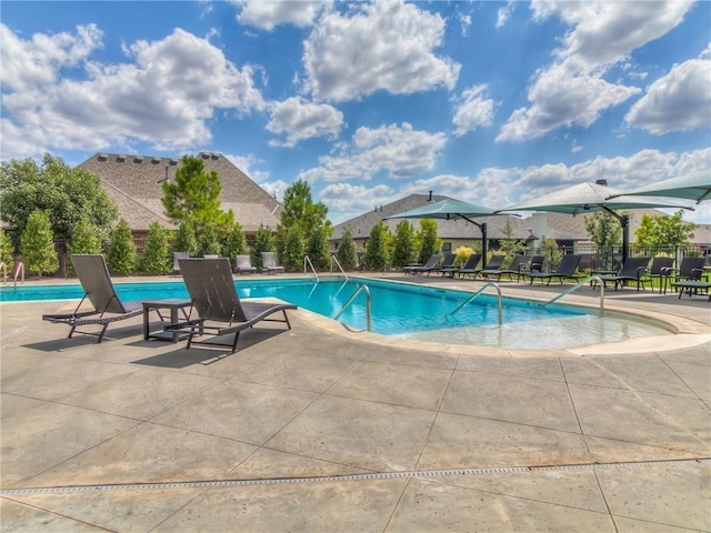 pool featuring a patio and fence