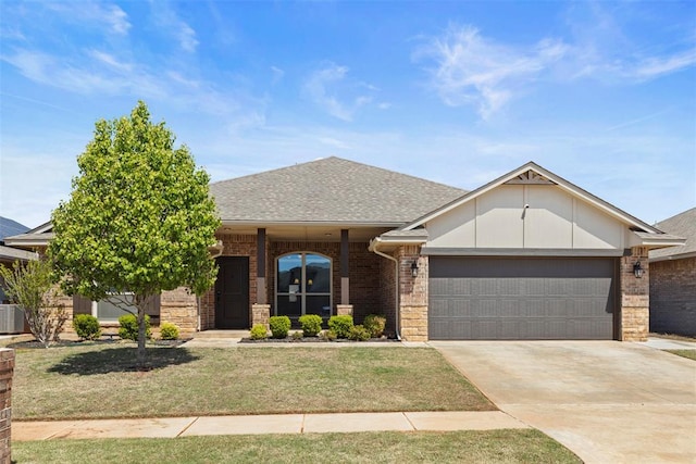 9233 SW 48th Ter, Oklahoma City, OK 73179 - view of front of home featuring roof with shingles, a front yard, brick siding, an attached garage, and driveway