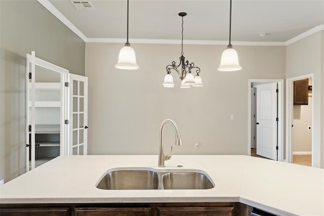 9233 SW 48th Ter, Oklahoma City, OK 73179 - kitchen featuring visible vents, light countertops, a sink, and ornamental molding
