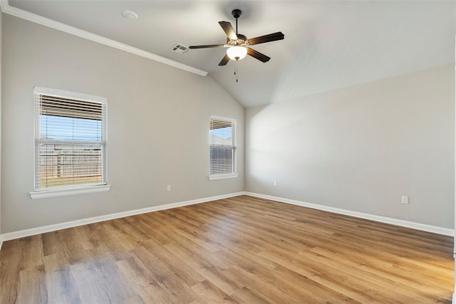 9233 SW 48th Ter, Oklahoma City, OK 73179 - empty room featuring baseboards, ornamental molding, ceiling fan, vaulted ceiling, and light wood-style flooring